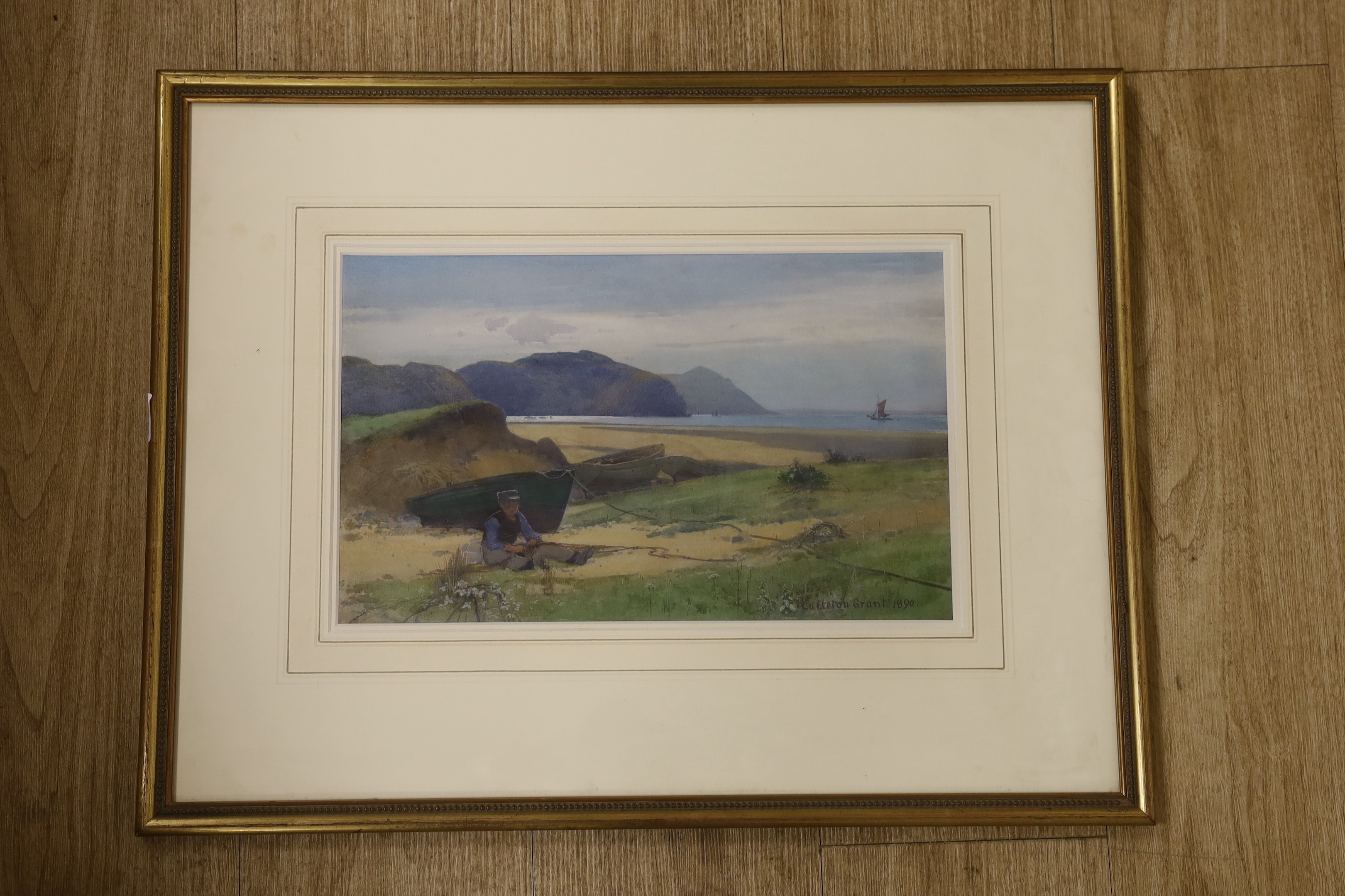 Carleton Grant (1860-1930), watercolour, Fisherboy mending nets on the seashore, signed and dated 1890, 24 x 39cm